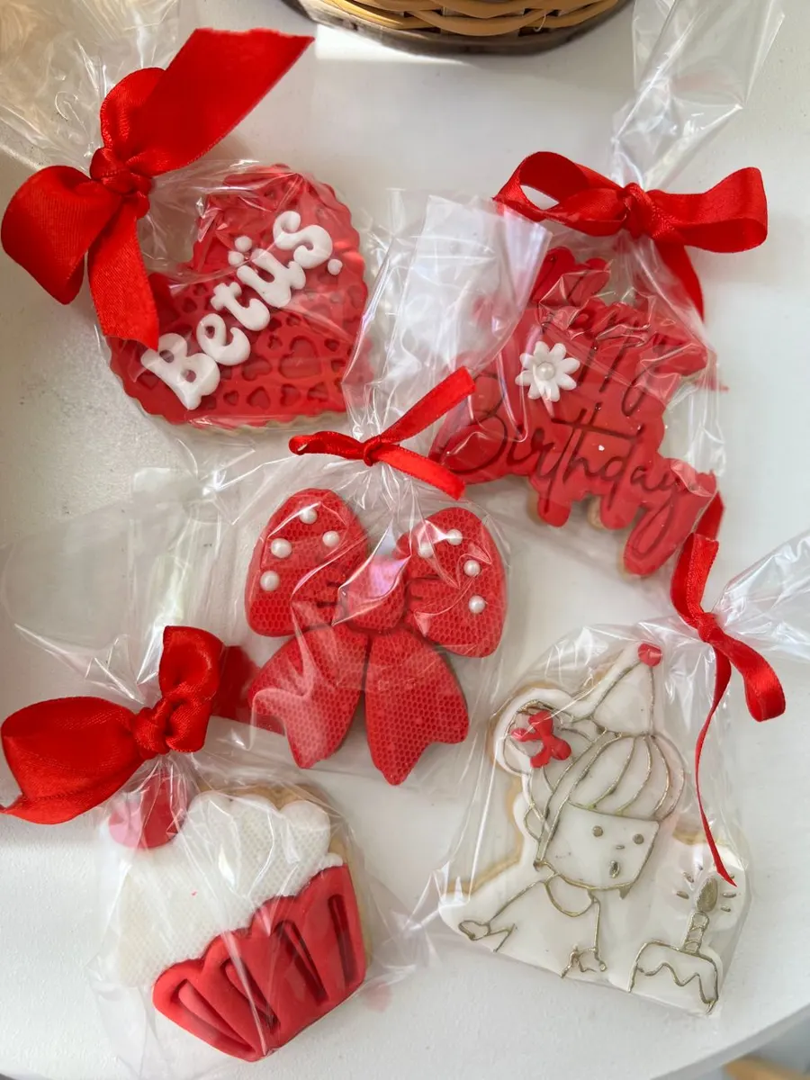 Birthday cookies wrapped with red ribbon