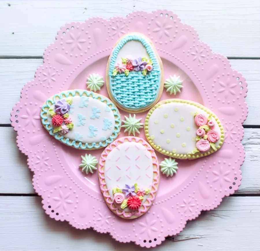 Floral egg cookies on a pink plate