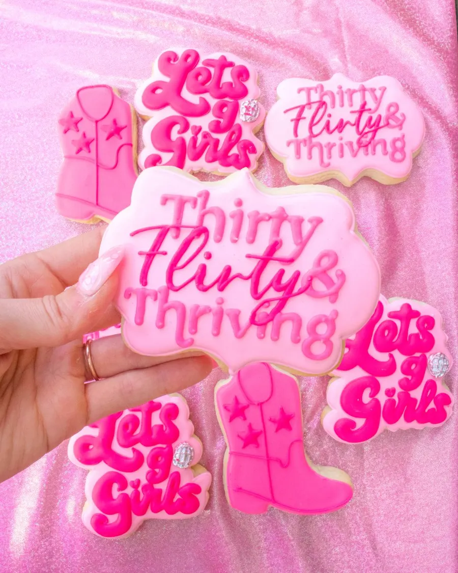 Pink birthday cookies with script lettering