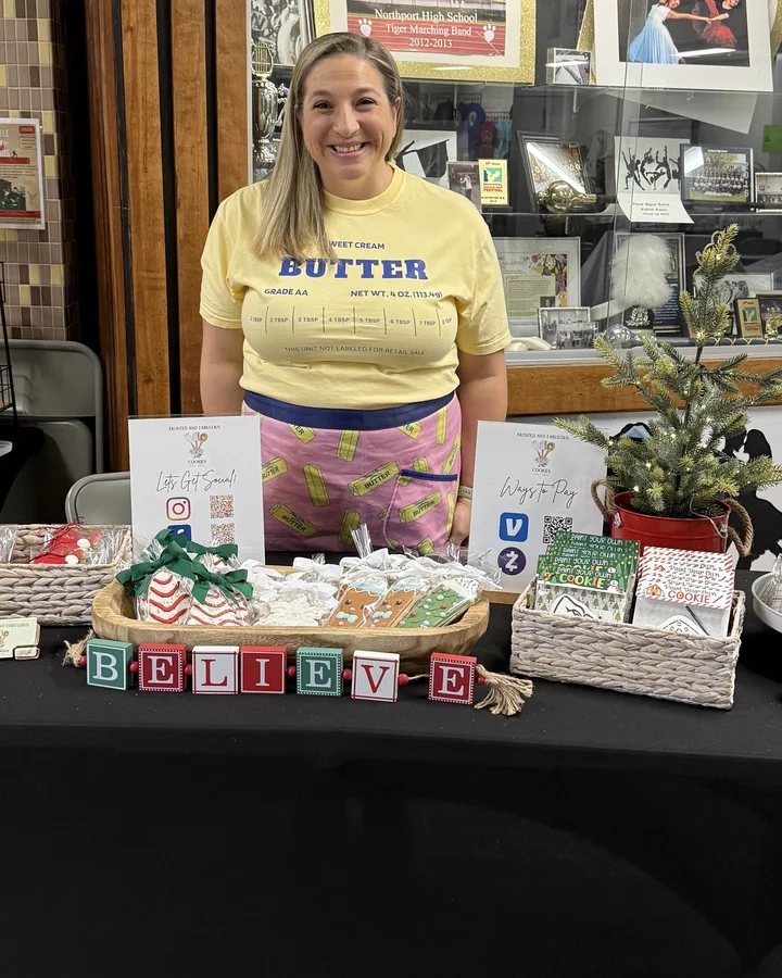 Jen at her Frosted and Fabulous Cookies table at a holiday fair